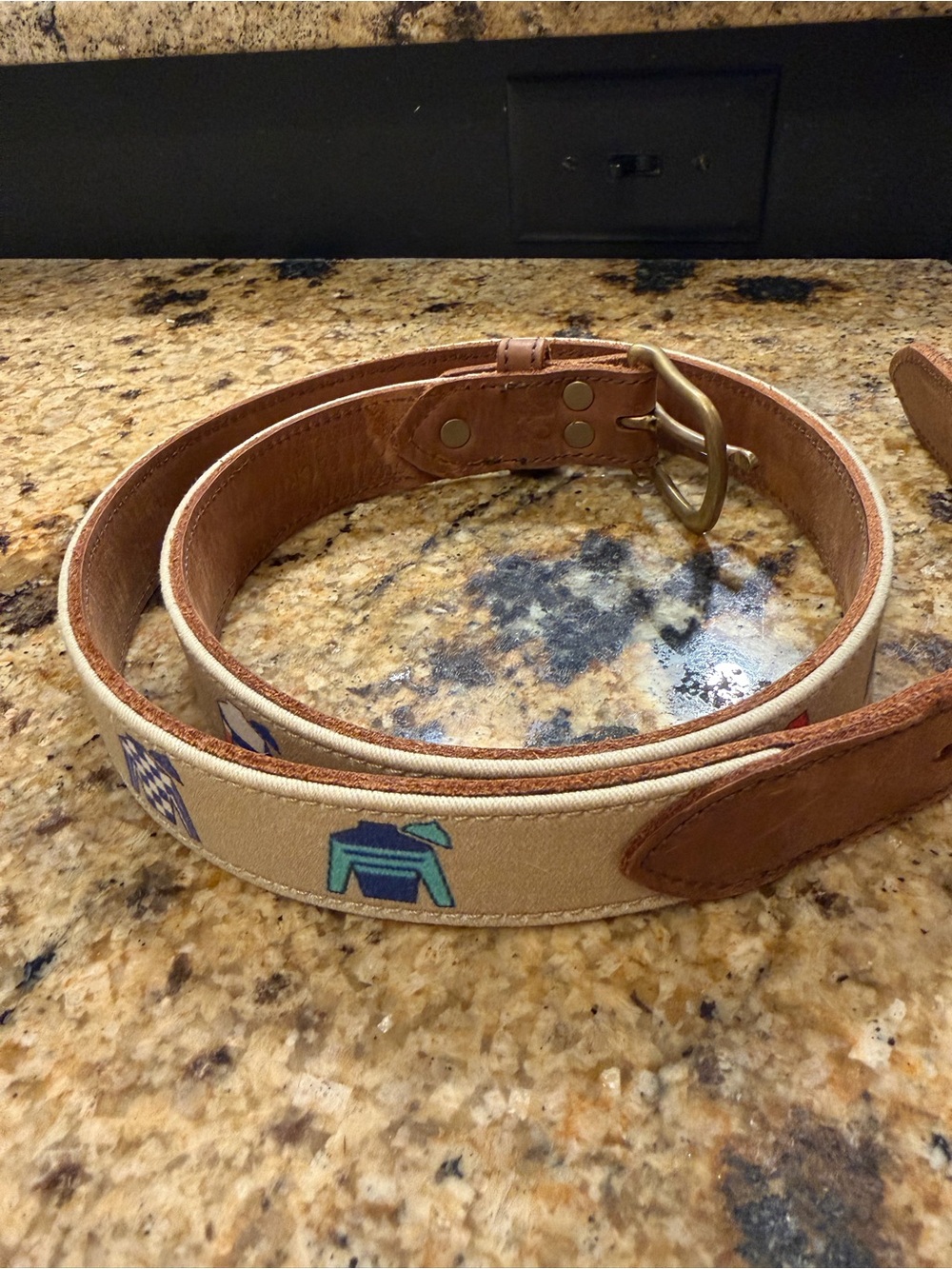 Tan leather belt with jockey jacket motif